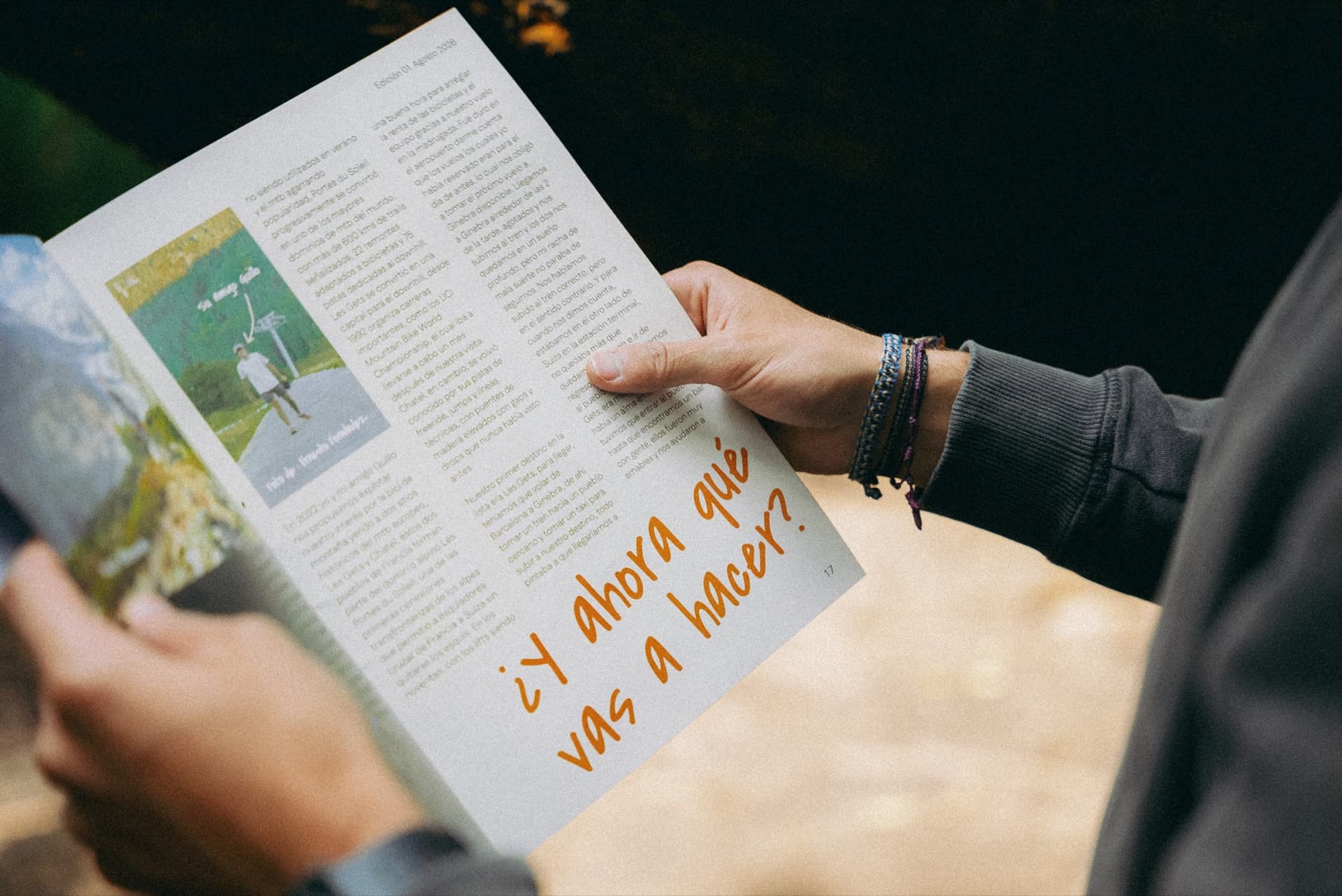 Hands holding the magazine open on a story