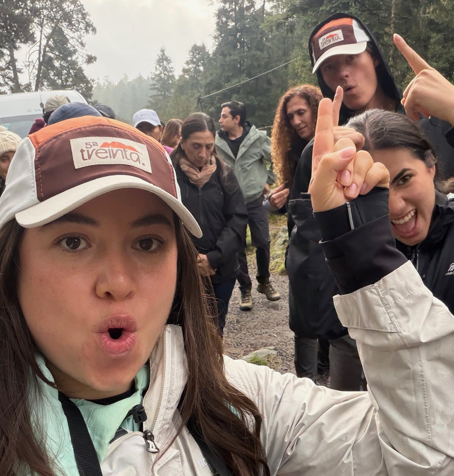 A selfie with the cap in the middle of a group heading out for a hike